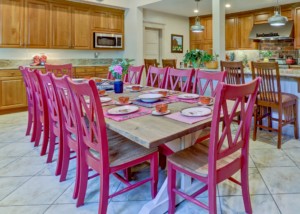 14-seat farmhouse kitchen table with pink chairs