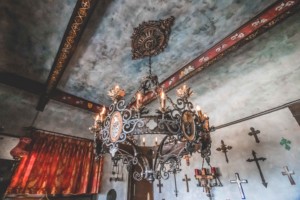 Gothic chandelier with wall of crucifixes