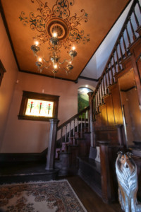 Shot of staircase with stained glass window of flowers on wall